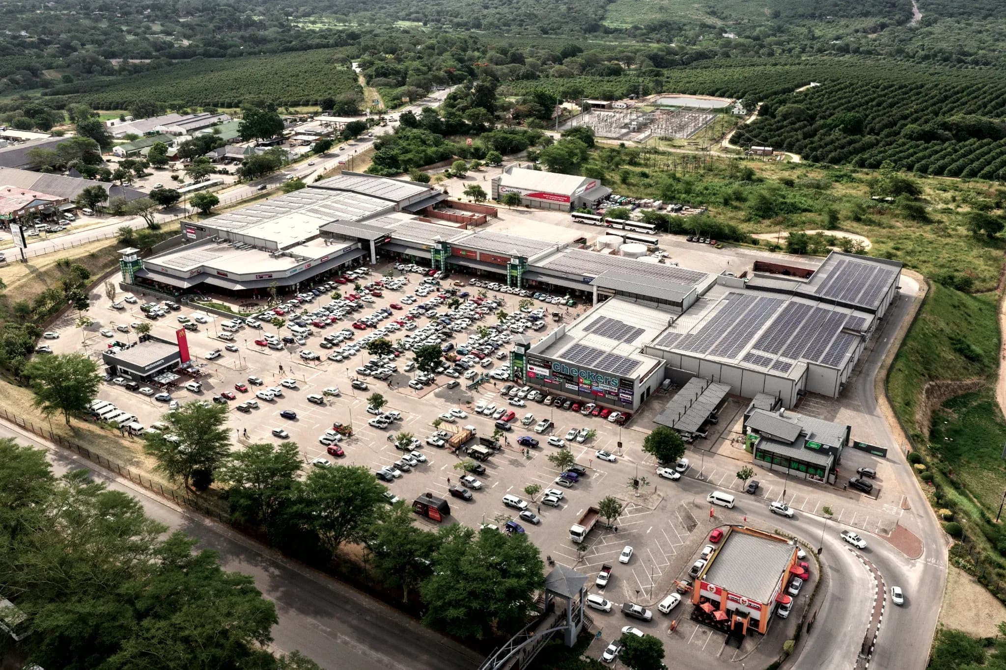 Hazyview Junction from the air, its parking full, set among the subtropical farmland of the Lowveld